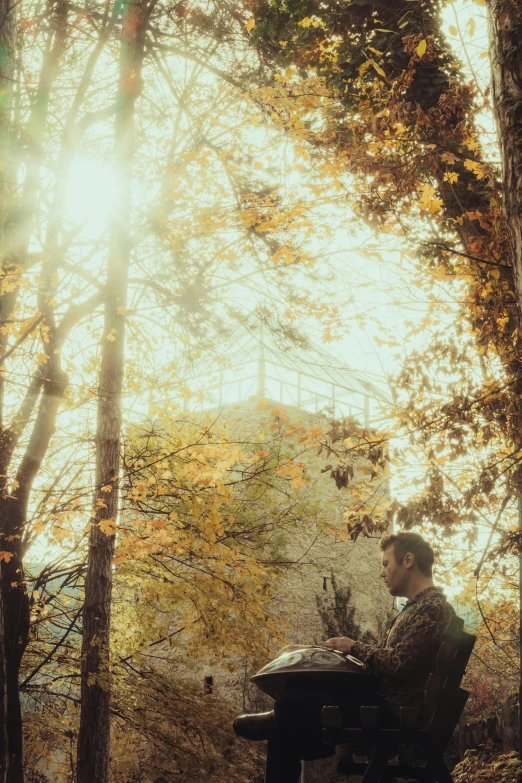 a man sitting at a table in the woods