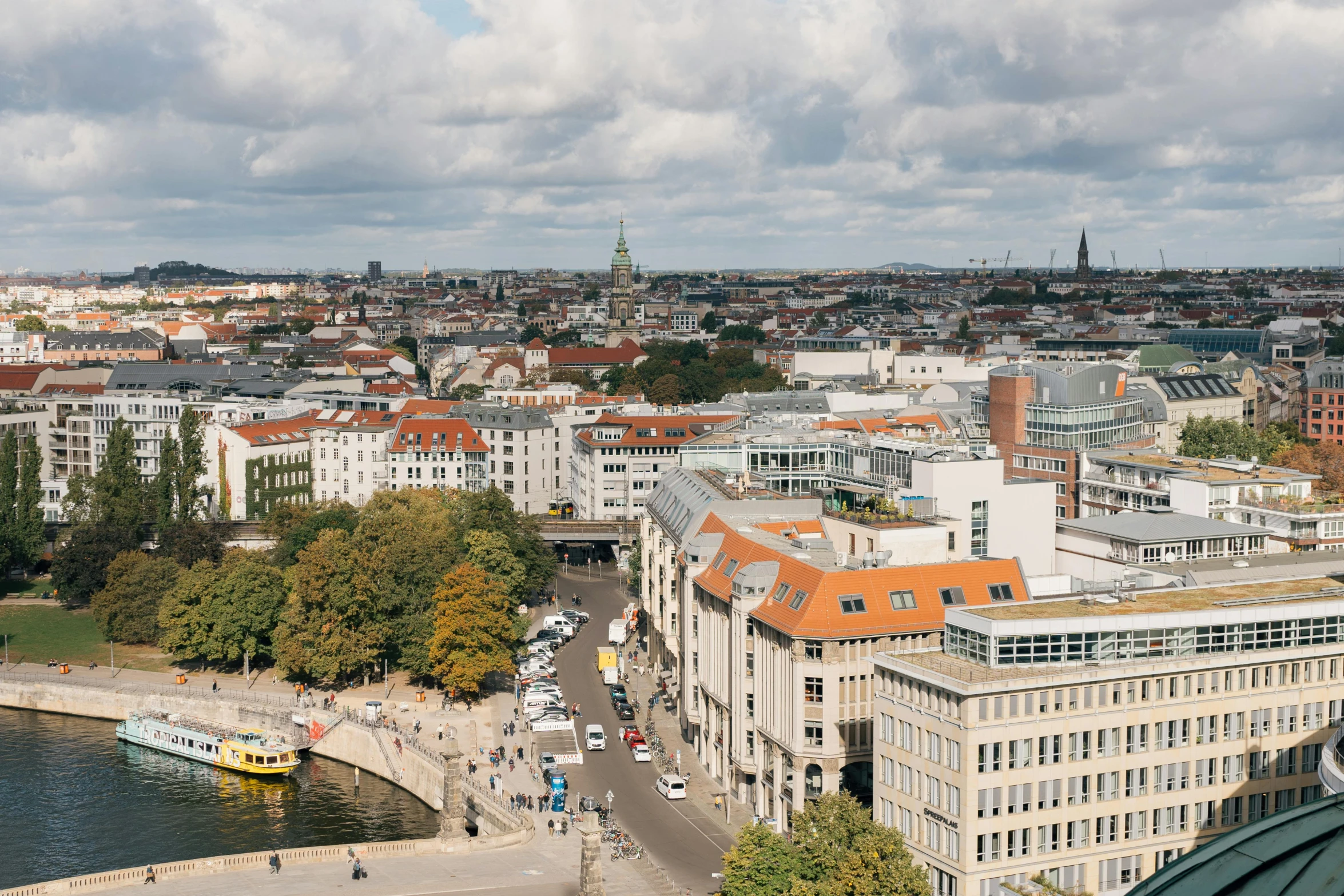 a city with a bridge and buildings next to it