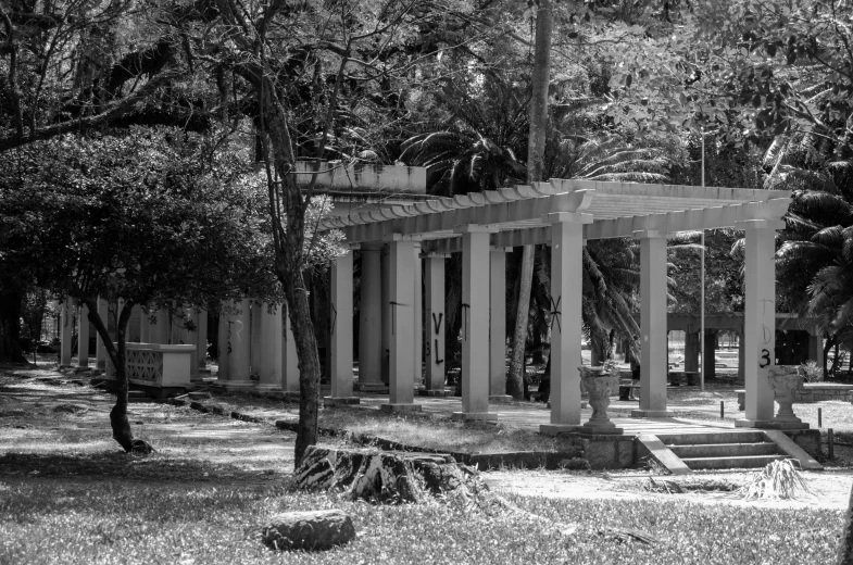 some large pillars and some trees and grass