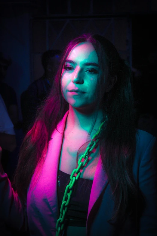 girl with necklace and celet in dark room