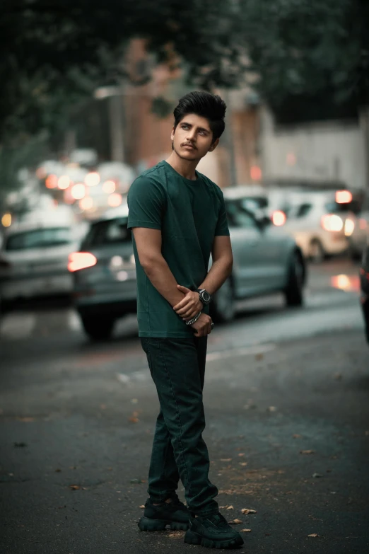 a man standing on the sidewalk in the middle of a street