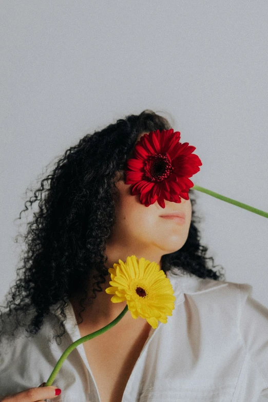 a woman with long hair and flower in her eyes