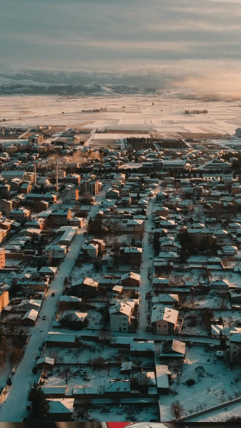 an aerial po of a city on the water