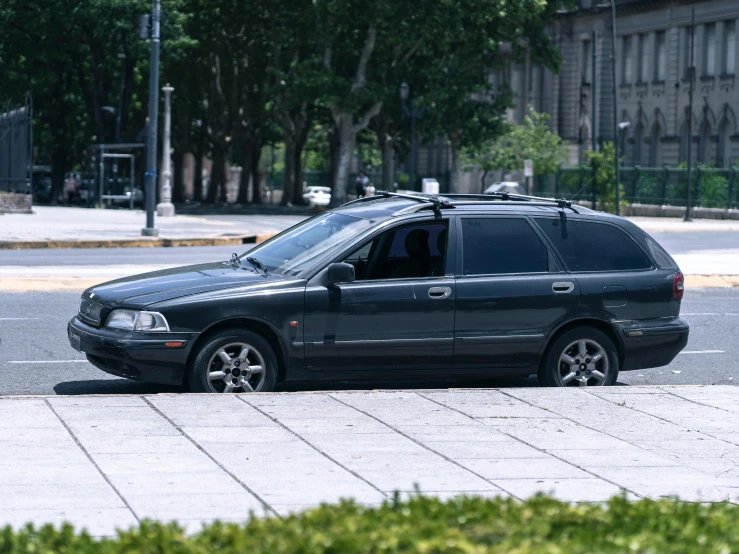 a black compact van with an attached light bar