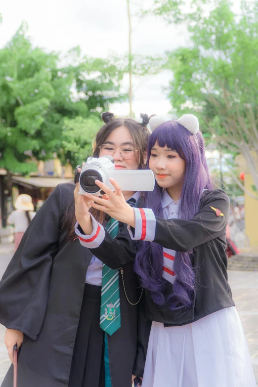 two women in school uniform are posing for a po