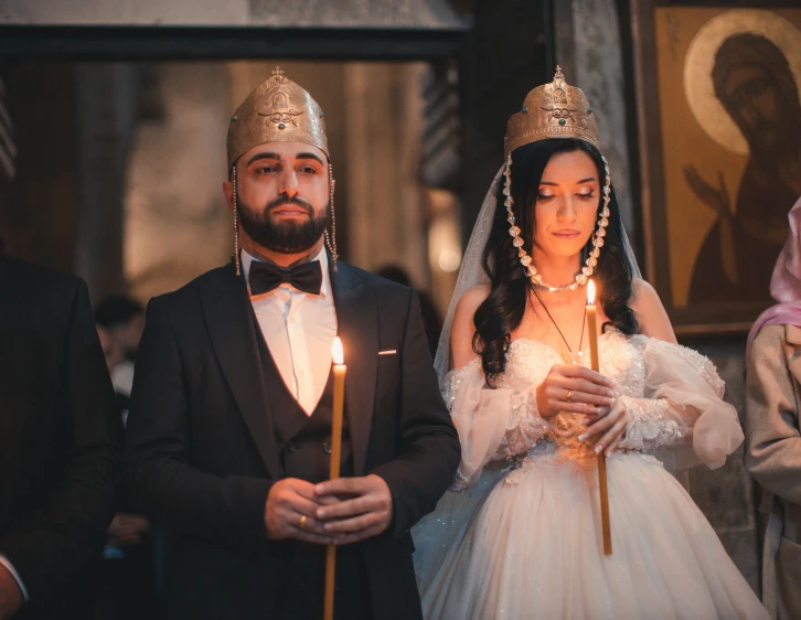 a couple walking down the aisle, dressed in traditional clothing