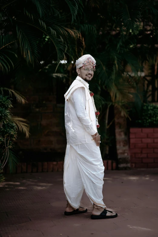 a man wearing a turban walking on a street