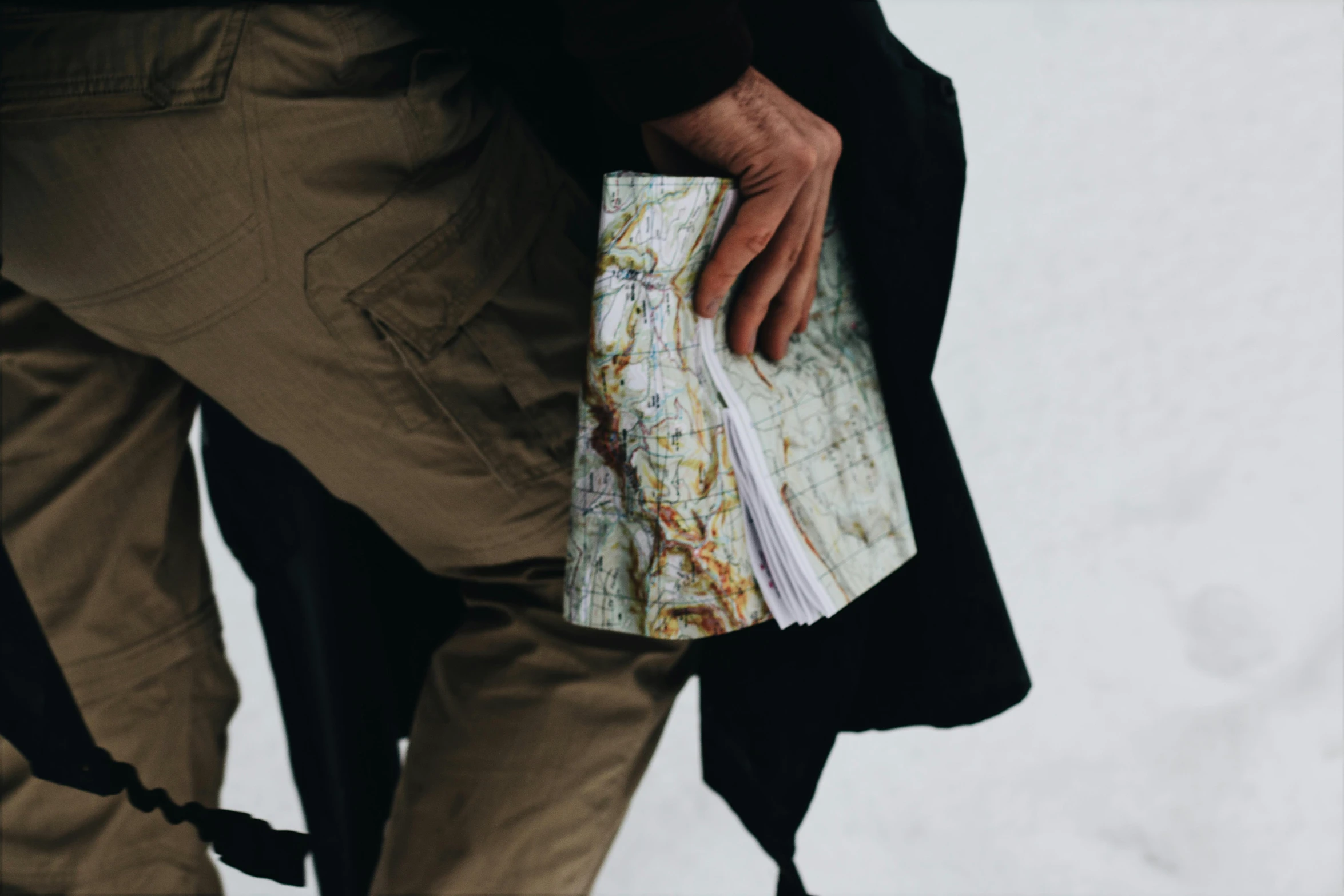 a person holds onto an old world map