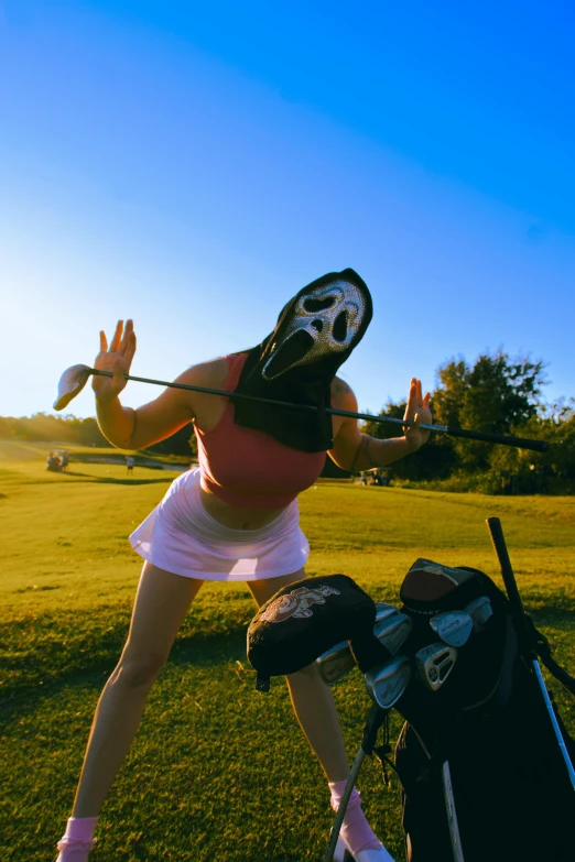 a female golf player is preparing for her s