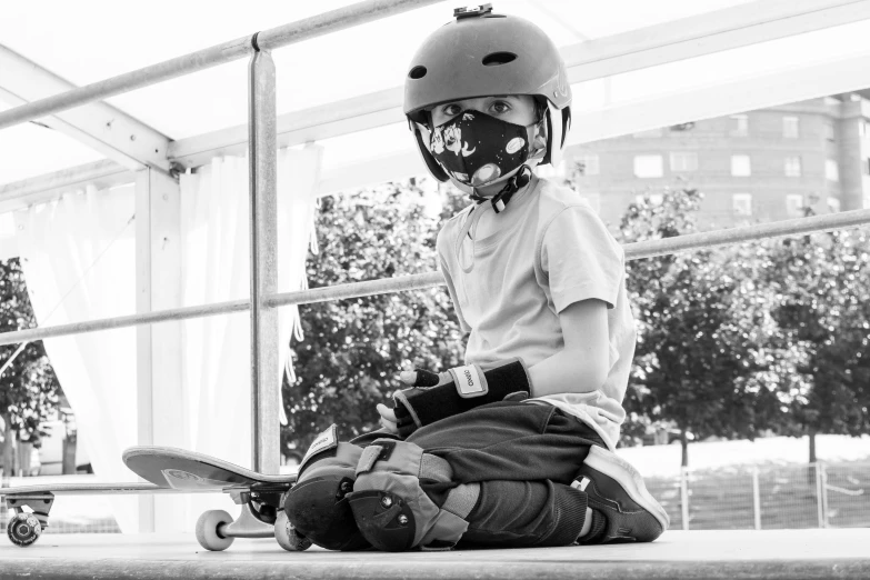 a little girl sitting on top of a skateboard