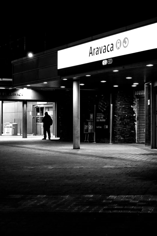 a person standing outside of an apartment building