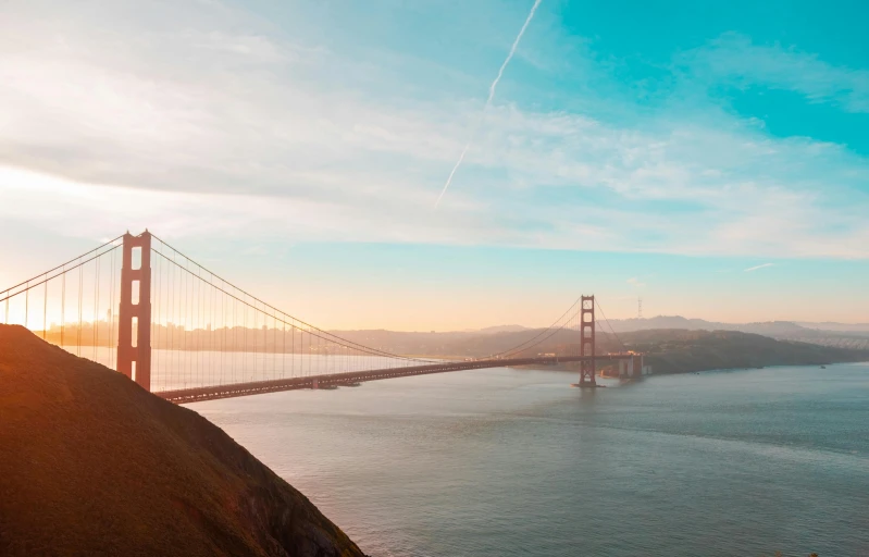 an aerial view of the golden gate bridge at sunset