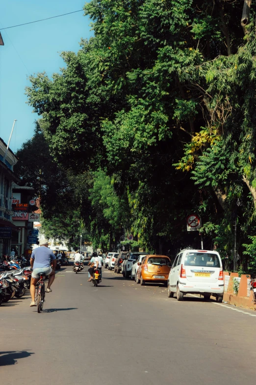 an image of people riding bikes on the street