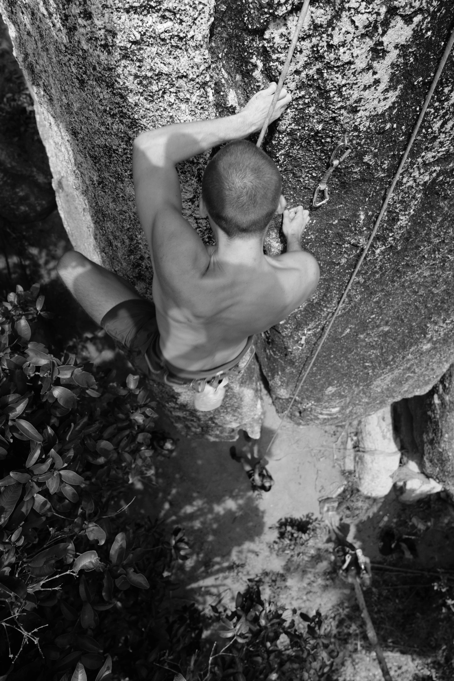 a man holding onto a rock as he climbs it