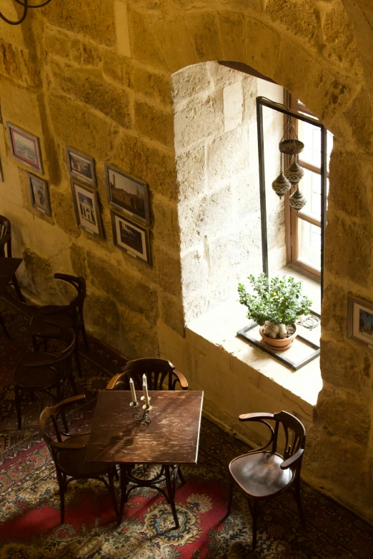 a chair next to a table near a window