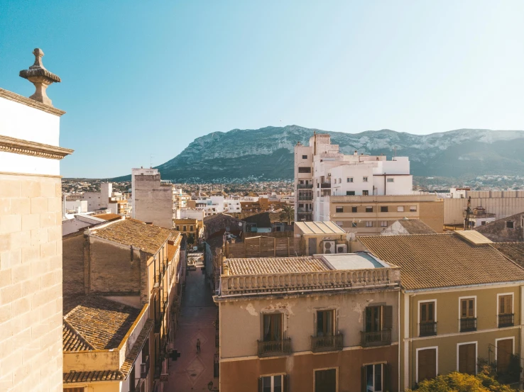 aerial view of an old street, mountains and buildings