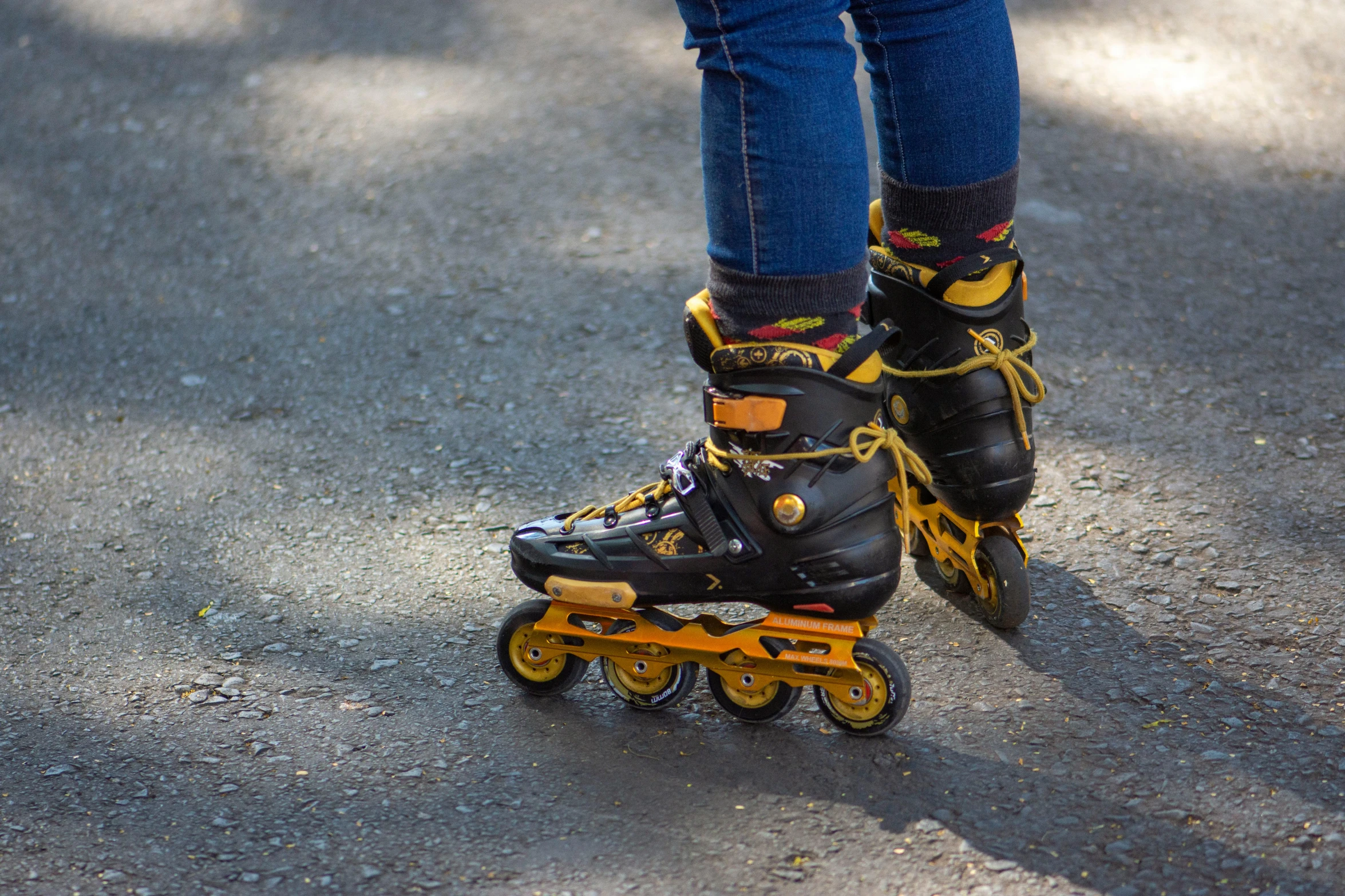 a person with black shoes and yellow roller skates