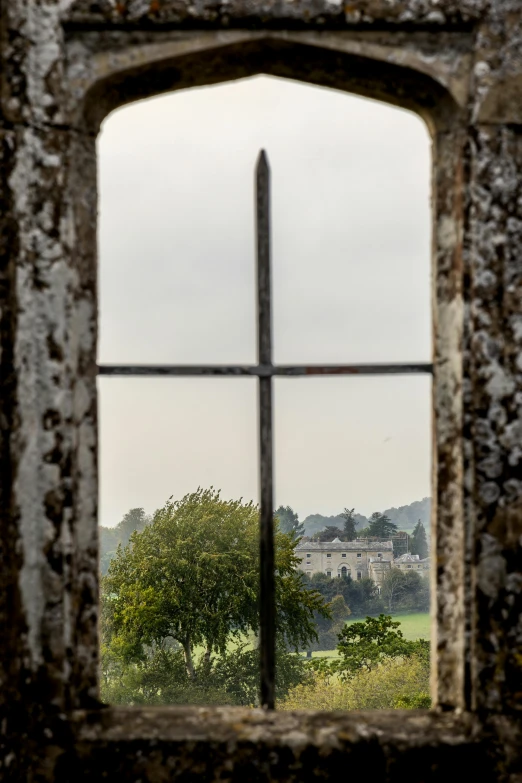 a window that has the view of an countryside from it