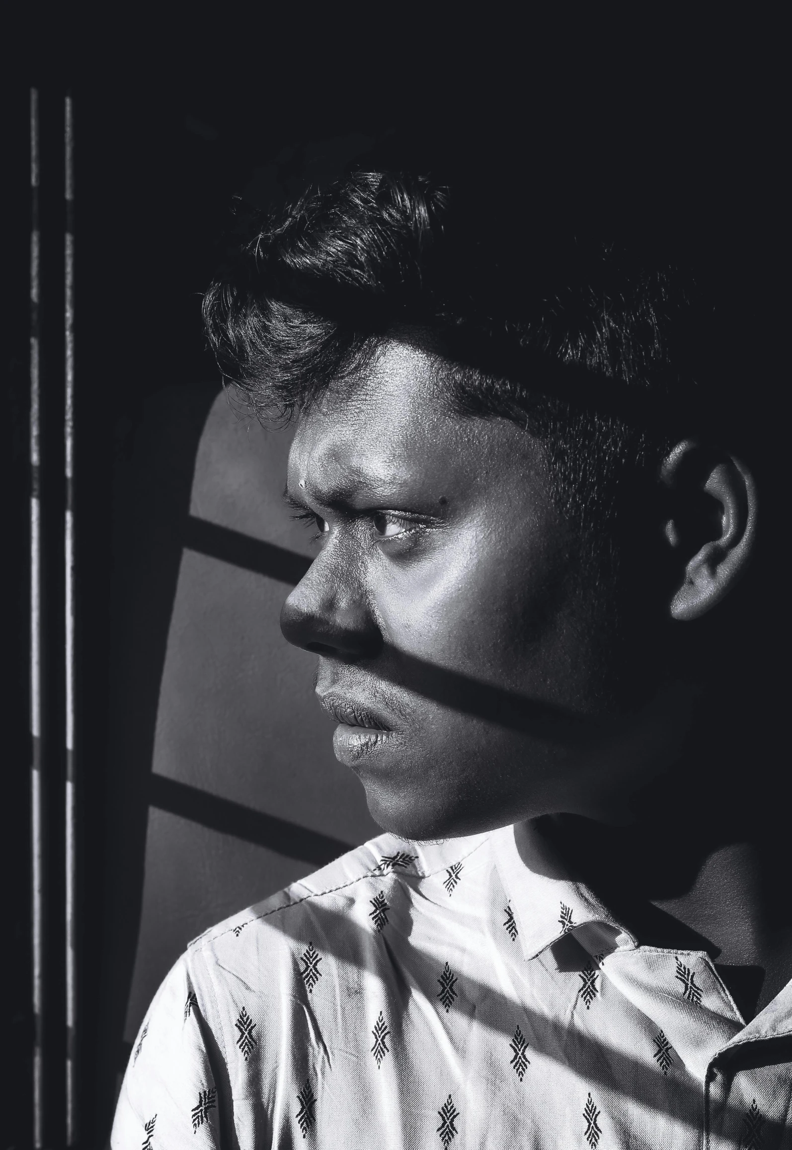 a man is standing behind a bar with his chin up