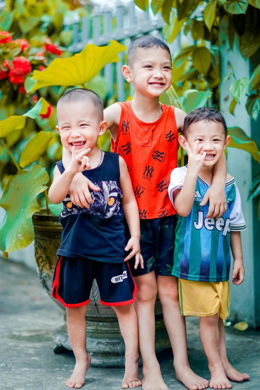 three little boys are smiling and posing for a po