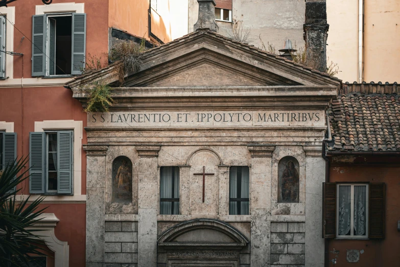 the facade of a stone building in front of some buildings