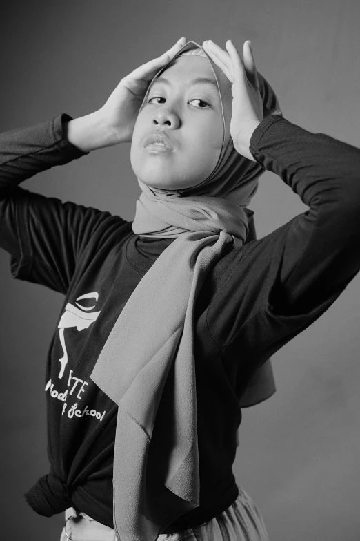 a woman in a scarf is posing for a black and white po