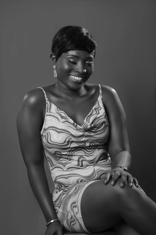 a woman is sitting on a toilet in black and white