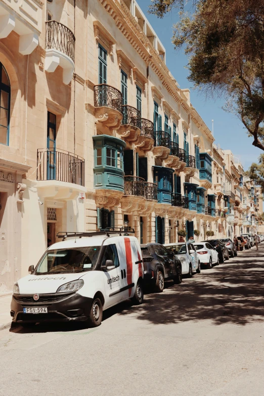 several vans parked on the side of a city street