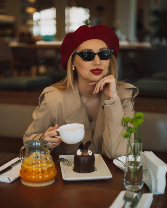 a woman is wearing a red hat and sunglasses