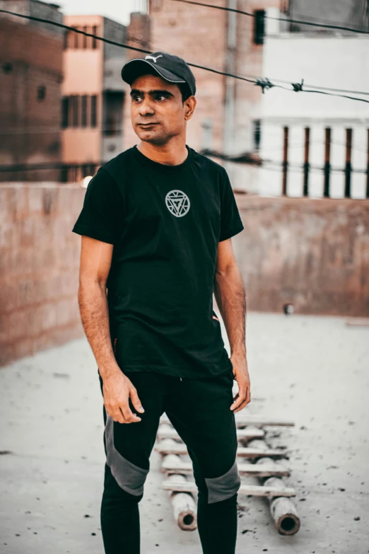 a man standing in front of a skateboard at an alley