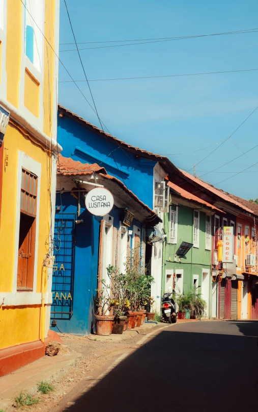 there is a very small town street with old fashioned buildings on each side