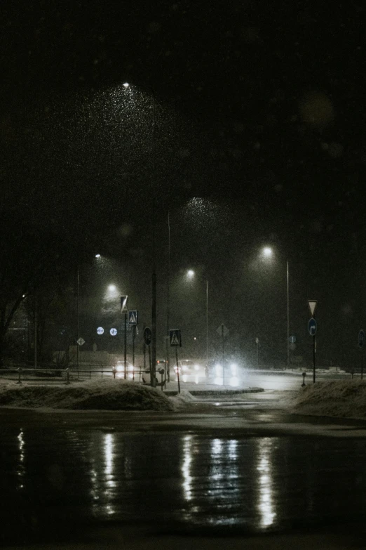 a night scene with street lights and cars traveling along the road