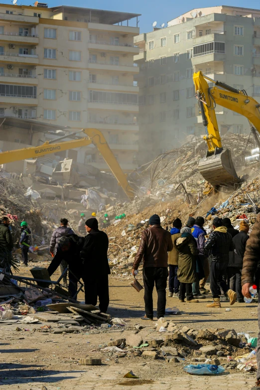 people standing outside with construction equipment in background