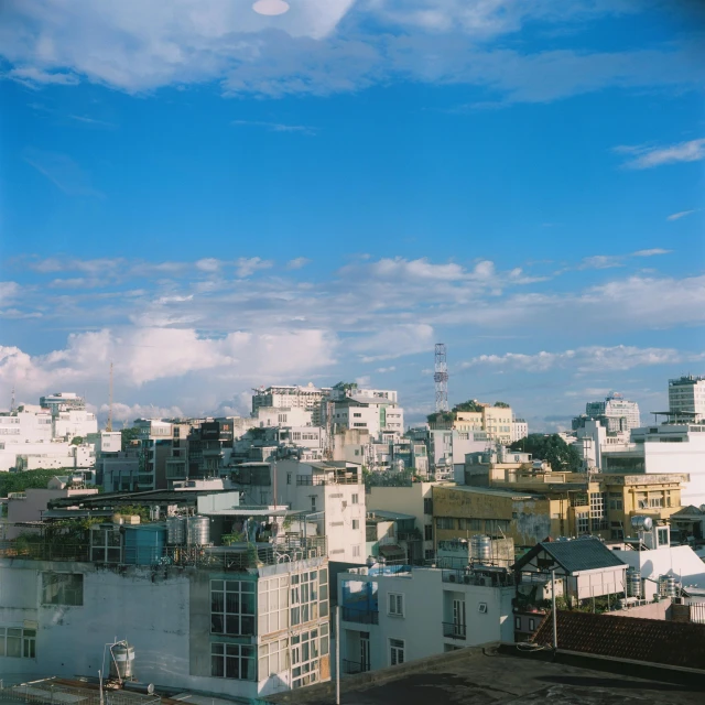 a city with lots of buildings and green trees