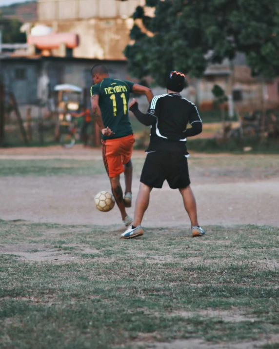 two men are standing on the field playing soccer