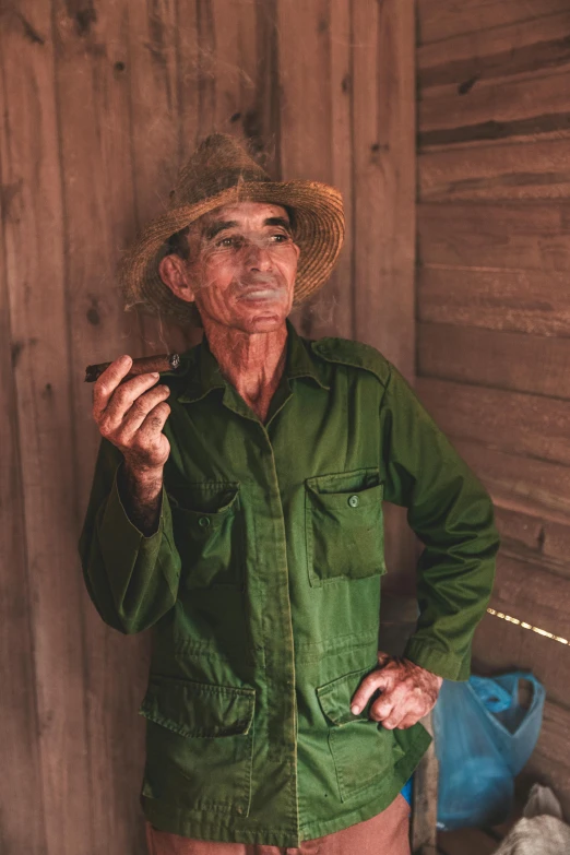 a man standing in front of a wooden structure