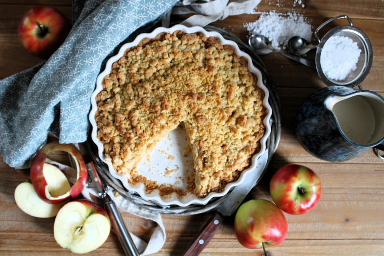 a pie with a slice missing is sitting on a wooden table