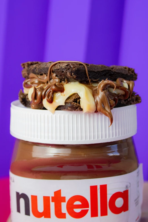 a peanut er sandwich is sitting on top of the nutella jar