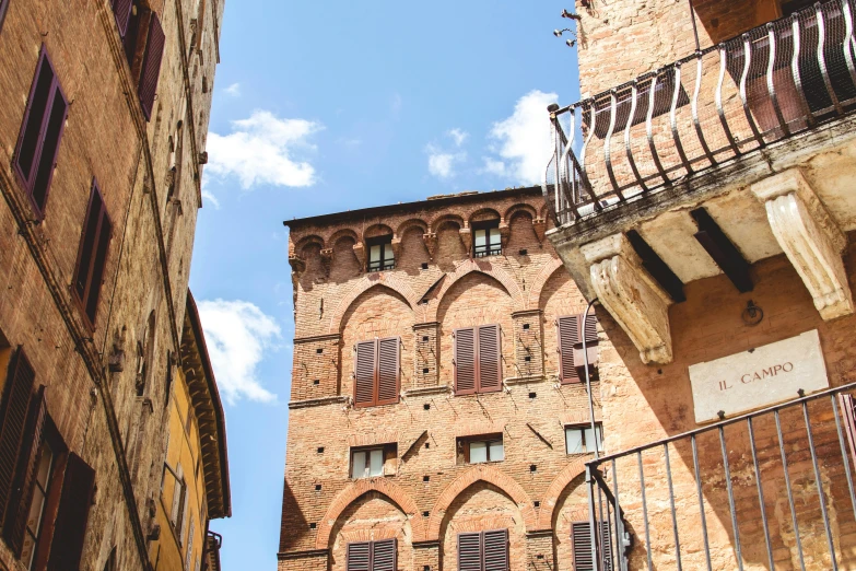 an old brick building next to a smaller brick building