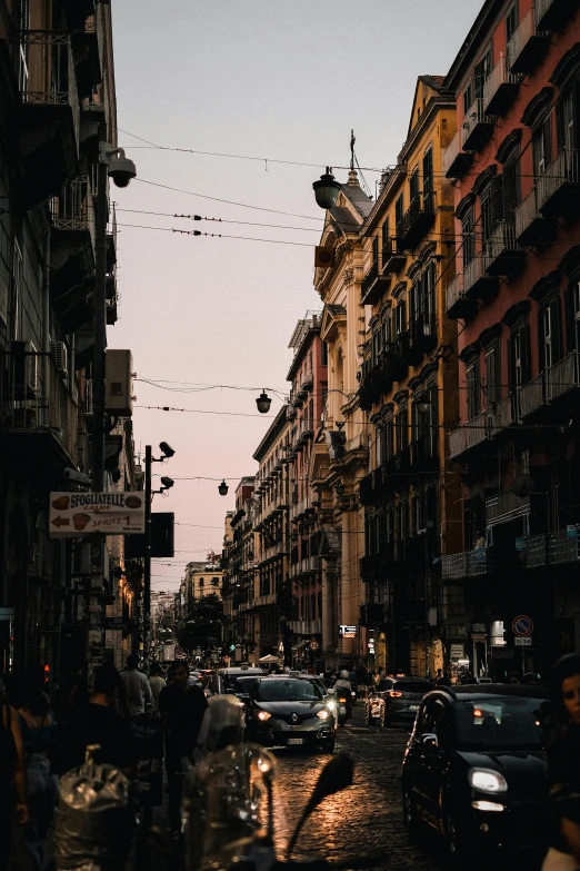 city street with parked cars and many buildings