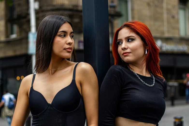 two young women dressed in lingerie in a city setting