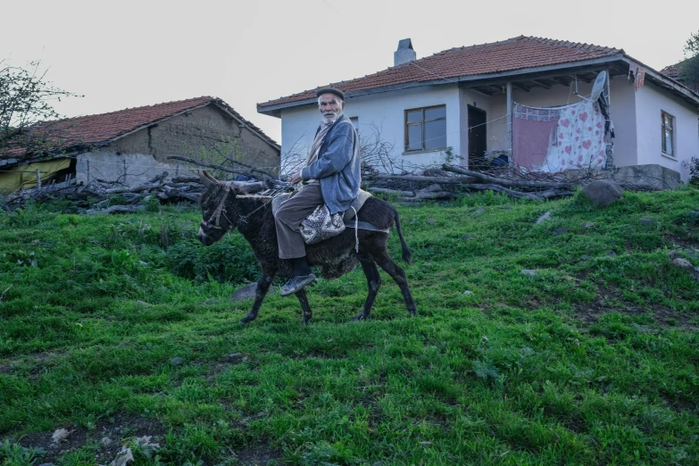 a man is riding a horse in front of a house