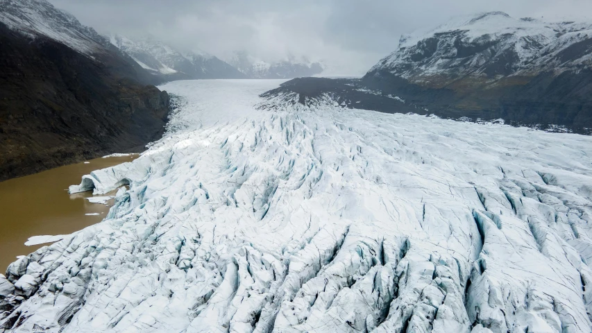 a very big icy mountain by some pretty lakes