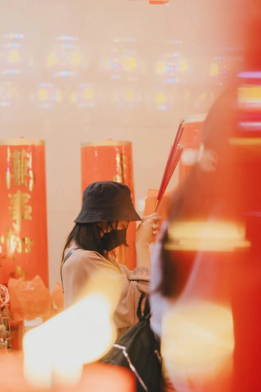 a woman stands by a table with candles on it