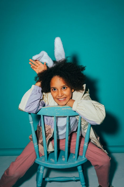 a  is sitting in a chair holding a stuffed animal