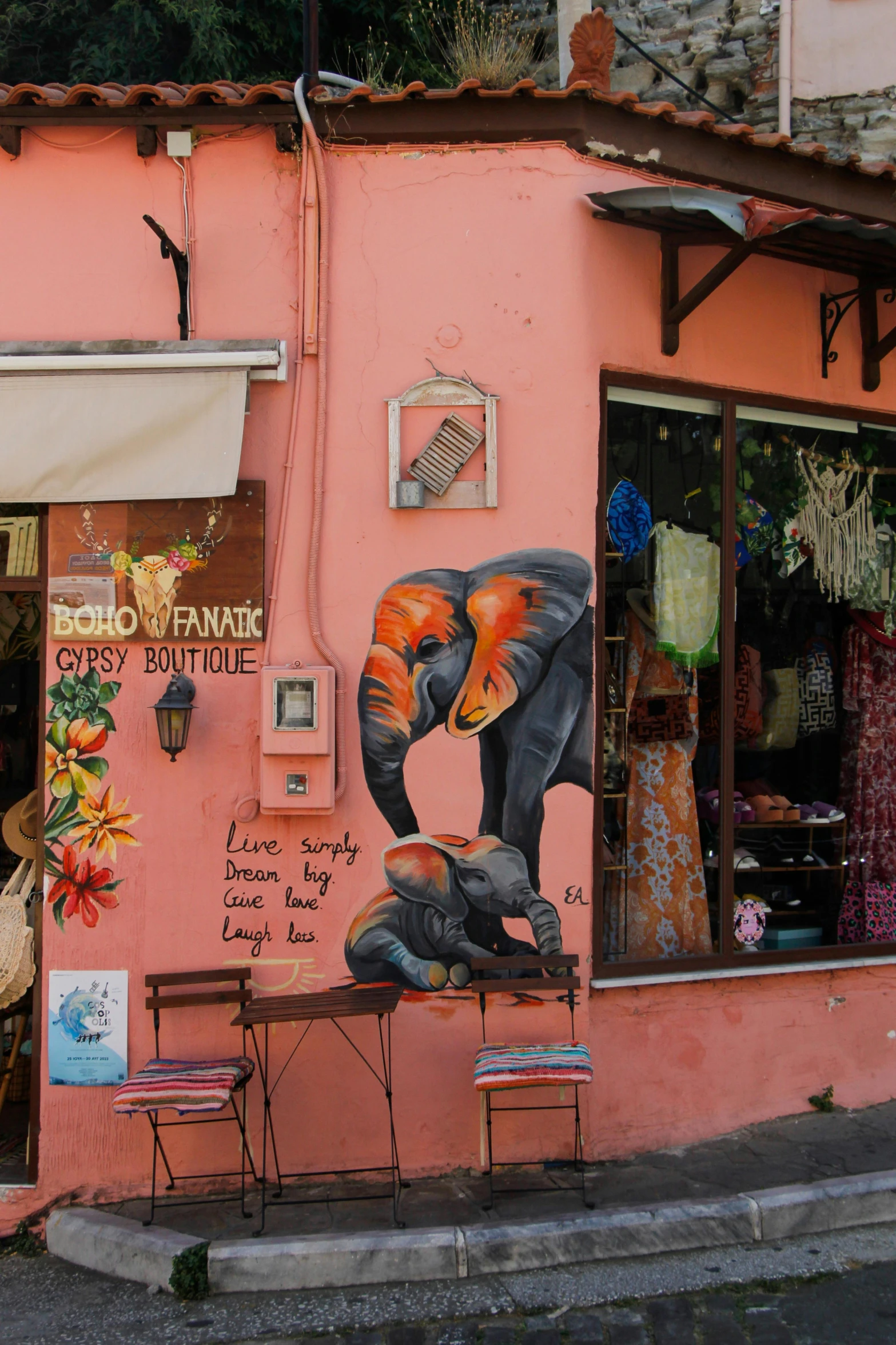 there are several street signs on the pink building