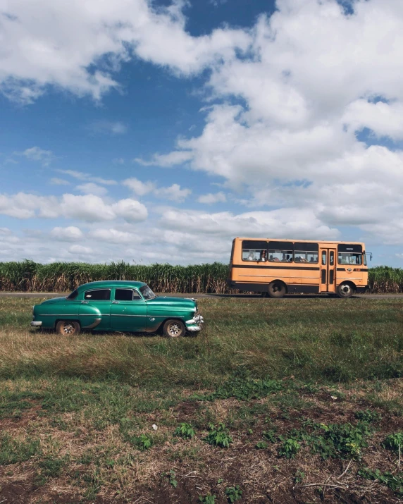 a truck and a bus driving in the grass