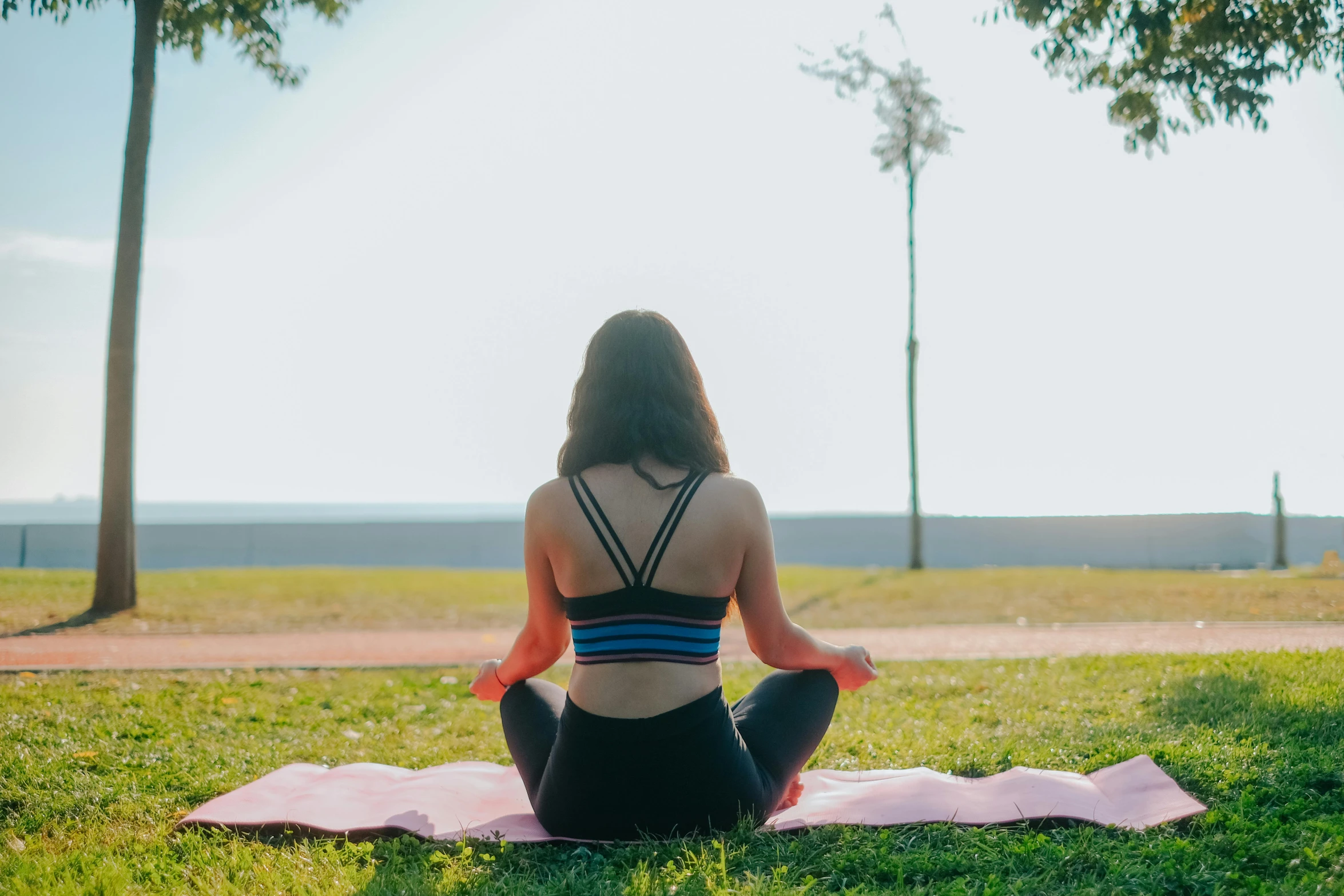 the woman is practicing yoga in the park