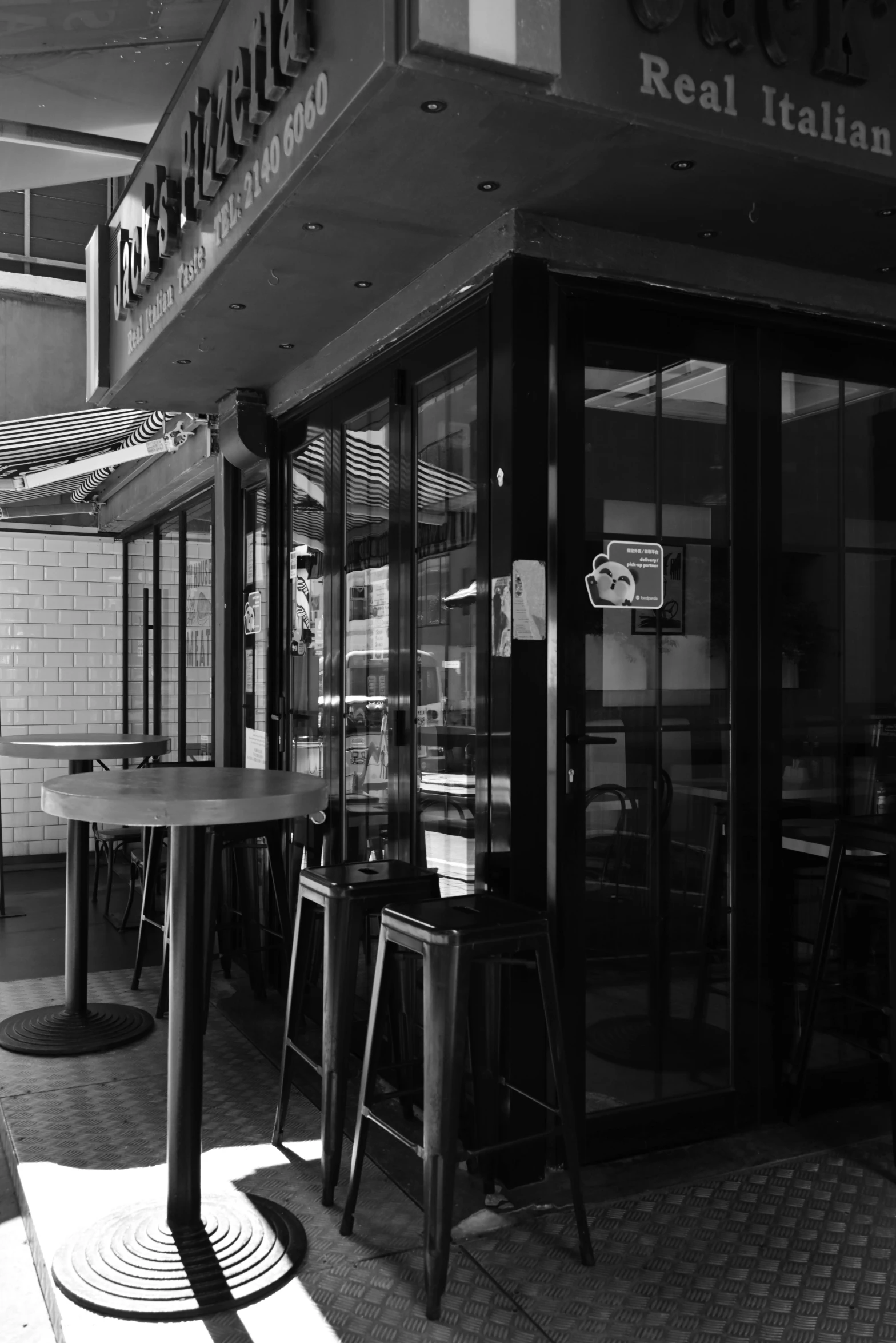 tables and chairs sitting outside of a restaurant