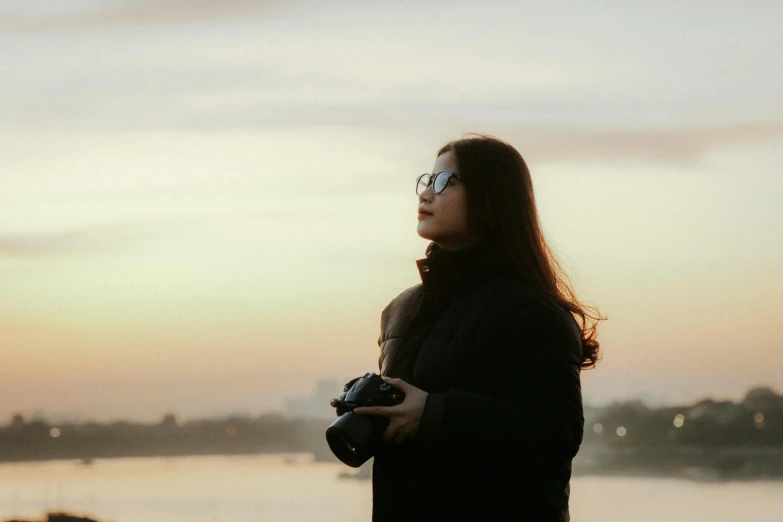 a woman holding a camera in her hand